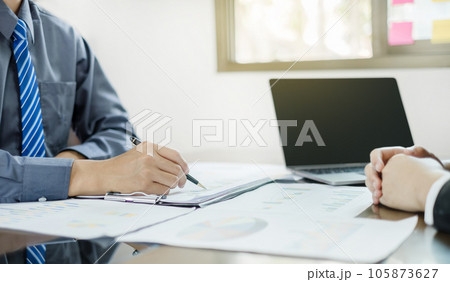 Two business leaders talk about charts, financial graphs showing results are analyzing and calculating planning strategies, business success building processes Two business leaders talk about charts, financial graphs showing results are analyzing and calculating planning strategies, business success building processes 105873627