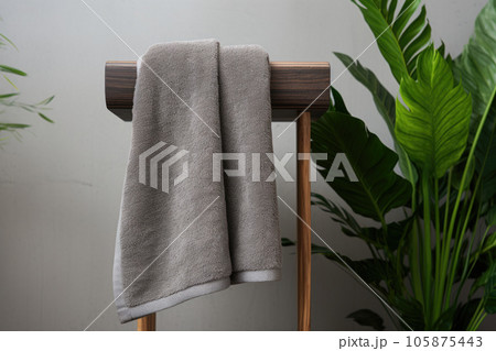 Gray terry towels in the bathroom near the green toilet Gray terry towels in the bathroom near the green toilet 105875443