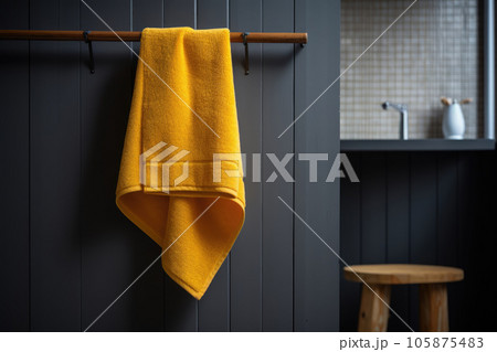 Yellow terry towel hanging in the bathroom Yellow terry towel hanging in the bathroom 105875483