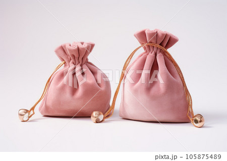 Pink suede fabric bags with laces for jewelry are on the table 105875489