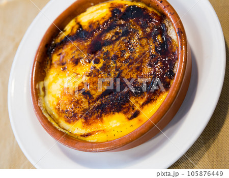 Sweet creme brulee dessert with caramel crust served at clay pot 105876449