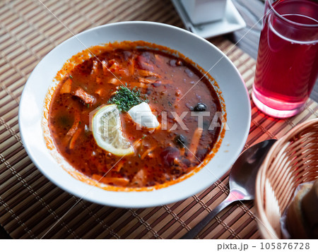 Traditional Russian meat soup Solyanka with sour cream and lemon Traditional Russian meat soup Solyanka with sour cream and lemon 105876728