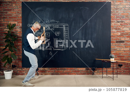 Man, professional architect making measurements, drawing architectural sketches, project on blackboard Man, professional architect making measurements, drawing architectural sketches, project on blackboard 105877819