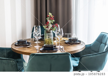 Dining room with wooden table and blue chairs floor in modern apartment Dining room with wooden table and blue chairs floor in modern apartment 105878283