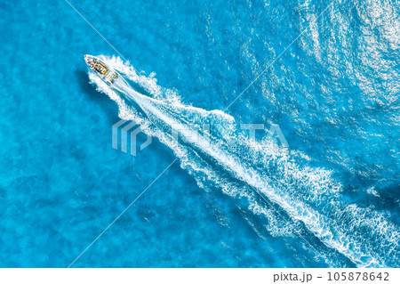 Aerial view on fast boat on azure Mediterranean sea at sunny day. Fast ship on the sea surface. 105878642