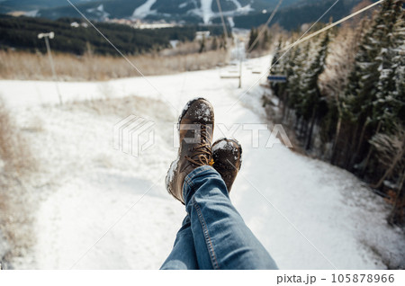 Feet in front of Chair lift during the rise to the top Feet in front of Chair lift during the rise to the top 105878966