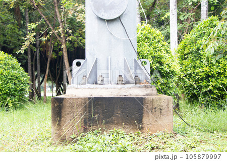 Large fasteners, screws and nut bolt for fixing bolts with large electric on cement pedestal pole iron powerful support in park. Spotlight pole It is technology that provides light in wide area. 105879997