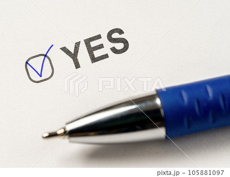 checkbox YES. marked with tick mark and blue pen on white paper background. Vote Yes. answer choice Yes. vote for, confirmation, consent, approval 105881097