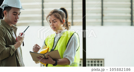 Young architect and engineer colleague workers working discussion, meeting and analyzing blueprint at construction site Young architect and engineer colleague workers working discussion, meeting and analyzing blueprint at construction site 105882186
