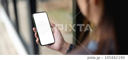 Female using smartphone blank screen display frameless. Gadget mockup design 105882190