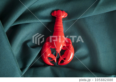 a lobster  on a green wavy fabric background 105882880