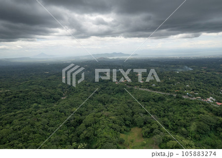 Green valley landscape with lake and volcano 105883274