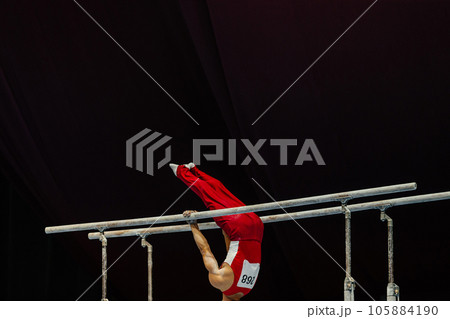 gymnast exercise parallel bars in championship gymnastics, element zhou shixioug 105884190
