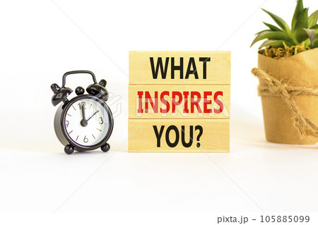 What inspires you symbol. Concept words What inspires you on wooden block. Beautiful white table white background. Black alarm clock. Business motivational what inspires you concept. Copy space. What inspires you symbol. Concept words What inspires you on wooden block. Beautiful white table white background. Black alarm clock. Business motivational what inspires you concept. Copy space. 105885099