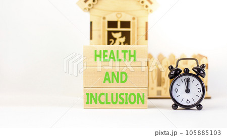 Health and inclusion symbol. Concept words Health and inclusion on wooden block. Beautiful white table white background. Black alarm clock. Business motivational health inclusion concept. Copy space. 105885103