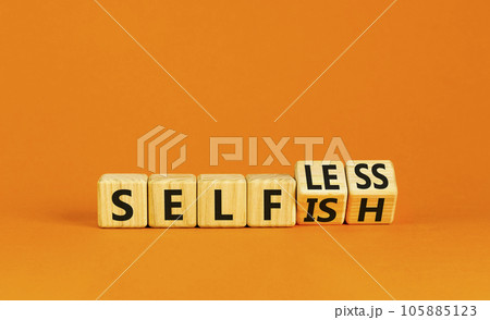 Selfish or selfless symbol. Psychologist turns cubes and changes the word selfish to selfless. Beautiful orange background, copy space. Business, psychological and selfish or selfless concept. 105885123