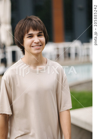 Portrait of teenager going to walk in the park. Happy smiled boy look into the camera 105885242
