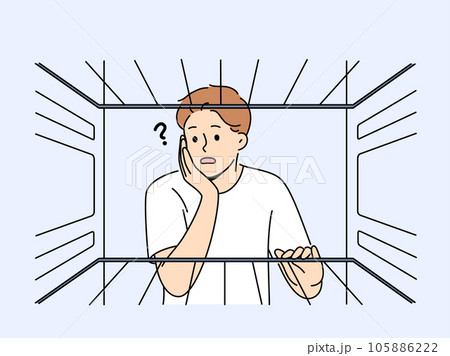 Hungry man sees empty refrigerator and is nervous about lack food due to poverty Hungry man sees empty refrigerator and is nervous about lack food due to poverty 105886222