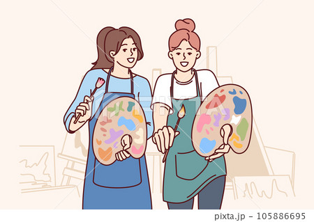 Two women artists hold brushes and palettes standing in workshop with easels to create artworks Two women artists hold brushes and palettes standing in workshop with easels to create artworks 105886695