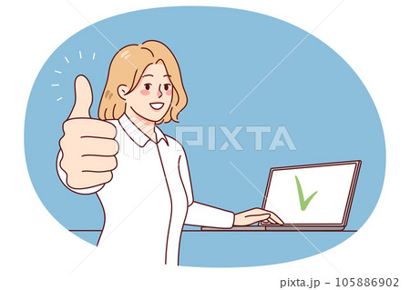 Smiling woman working on laptop showing thumb up 105886902