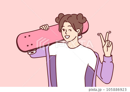 Little girl skateboarder shows victory gesture holding skateboard on shoulder and winks 105886923