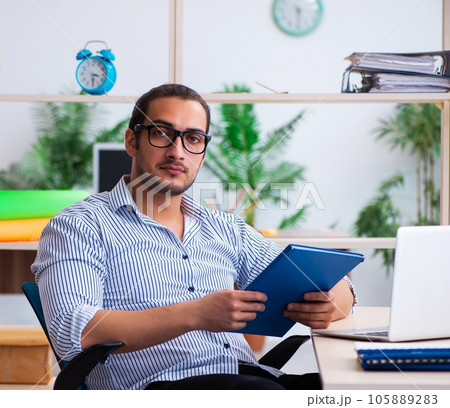 Young male employee working in the office Young male employee working in the office 105889283