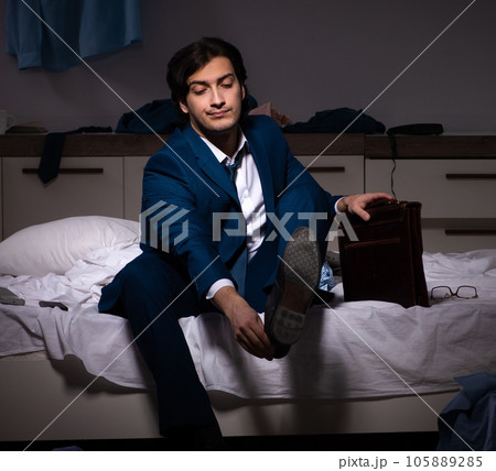 Young employee working at home after night shift Young employee working at home after night shift 105889285