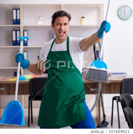 Young handsome contractor cleaning the office 105889621