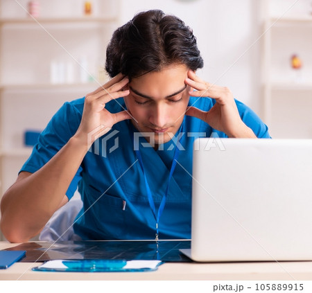 Young handsome doctor working in the clinic 105889915