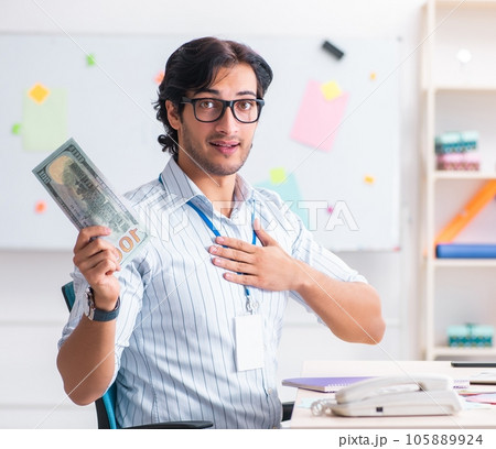 Young handsome male designer working in the office Young handsome male designer working in the office 105889924