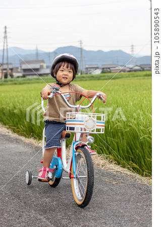 補助輪付きの自転車に乗る子どもの写真素材 [105890543] - PIXTA