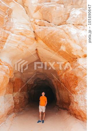 Young hiker man on popular trail Belly of the Dragon Tunnel Cave in Kanab Young hiker man on popular trail Belly of the Dragon Tunnel Cave in Kanab 105890647