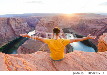 Happy man on the edge of the cliff. Horseshoe Bend Canyon in Page, Arizona. Adventure and tourism concept 105890784