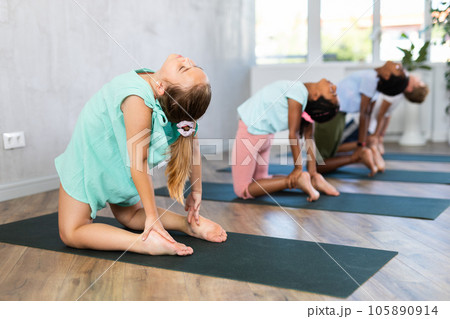 Kids exercise on yoga mats. Kids exercise on yoga mats. 105890914