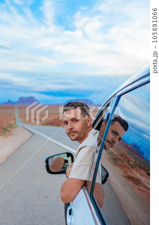 Young man travel by car in famous Monument Valley in Utah 105891066