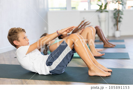 Young boy doing pilates in group of children 105891153