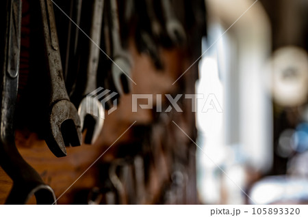 Set of wrenches mounted on a wall in a workshop. Set of wrenches mounted on a wall in a workshop. 105893320