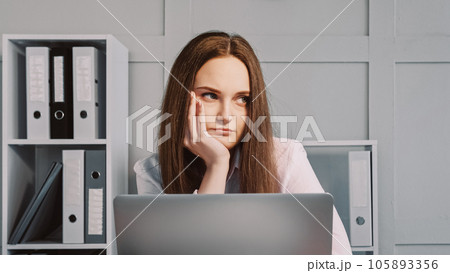 Bored work. Office sad. Unhappy uninterested lazy woman leaning on head laptop job sitting at workplace with upset displeased face. Bored work. Office sad. Unhappy uninterested lazy woman leaning on head laptop job sitting at workplace with upset displeased face. 105893356