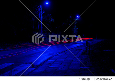 Lights of cars at night. Street line lights. Night highway city. Long exposure photograph night road. Colored bands of red light trails on the road. Background wallpaper defocused  105896832