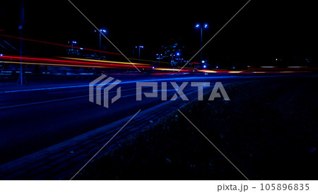 Lights of cars at night. Street line lights. Night highway city. Long exposure photograph night road. Colored bands of red light trails on the road. Background wallpaper defocused Lights of cars at night. Street line lights. Night highway city. Long exposure photograph night road. Colored bands of red light trails on the road. Background wallpaper defocused 105896835