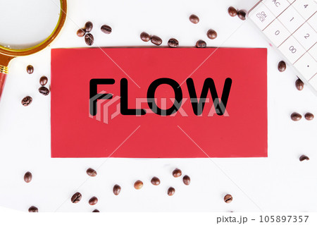 FLOW writing on a red card on a white background with coffee beans and a magnifying glass 105897357