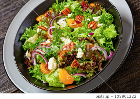 Mandarin Orange Salad in black bowl, top view Mandarin Orange Salad in black bowl, top view 105901222