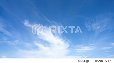Blue sky and white cirrocumulus clouds texture background. Blue sky on sunny day. Summer sky. Cloud formation. Fluffy clouds. Nice weather in summer season. Weather pattern. Atmospheric phenomenon. 105901547