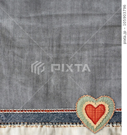 Grey and light grey  denim background with a seam and felt heart. Light gray color denim jeans fabric texture. Valentine's day denim backdrop. Copy space for text 105903796