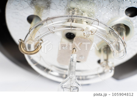 Studio light flash lamp closeup on white background isolated Studio light flash lamp closeup on white background isolated 105904812