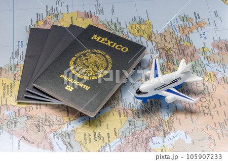 Mexico City, Mexico. Aug 3, 2023. Mexican passport next to an airplane on a world map. Concept 105907233