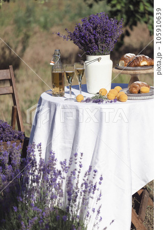 lemonade, croissants and apricots on a table in the garden 105910639