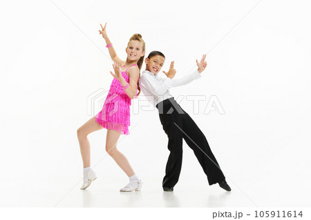 Beautiful, stylish children boy and girl dancing retro style dance, performing against white studio background 105911614