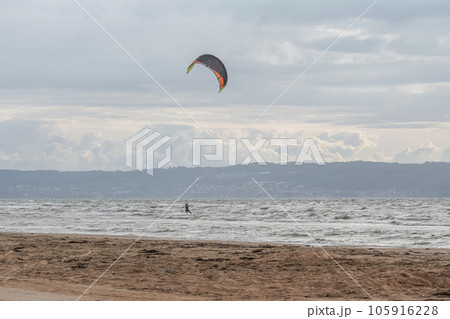 Melbystrand Sweden A kitesurfer practise his surfing skills close to beach with sand dunes Melbystrand Sweden A kitesurfer practise his surfing skills close to beach with sand dunes 105916228