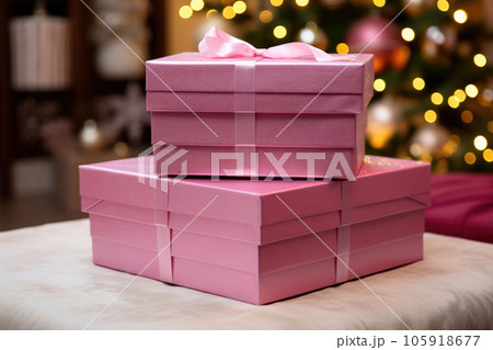A set of pink gift boxes near the Christmas tree 105918677